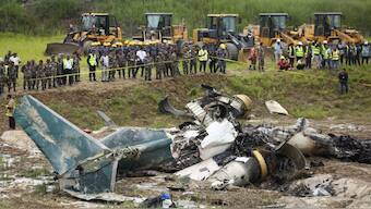 Nepal army personnel cordon off a plane crash site at Tribhuvan International Airport in Kathmandu, Nepal. A plane slipped off the runway and crashed while trying to take off from the Kathmandu airport. AP