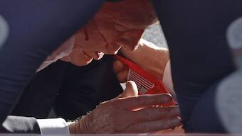 Secret Service tend to US former President Donald Trump onstage at a rally in Butler, Pennsylvania. Butler County district attorney Richard Goldinger said the shooter is dead after killing one audience member and injuring another in the shooting. AFP