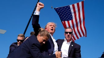 Republican presidential candidate former US President Donald Trump is surrounded by US Secret Service agents after an assassination attempt at a campaign rally in Butler, Pennsylvania, July 13, 2024. File Image/AP