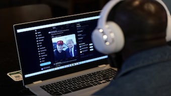 A person tries to watch on a laptop billionaire entrepreneur Elon Musk's interview with Republican presidential candidate and former US President Donald Trump on the X social media network, in New York City, US, August 12, 2024. Reuters