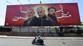 Portraits of slain leaders, Ismail Haniyeh of Hamas, Iranian Quds Force chief Qasem Soleimani (C), and Hezbollah senior commander Fuad Shukr on the road to Beirut airport on August 3, 2024. AFP