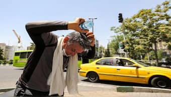 A man pours water on his head from a bottle to cool off during a heatwave in Tehran in July 2023. File Image: AFP