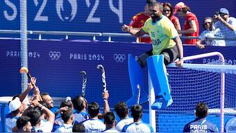 Inda goalkeeper PR Sreejesh sits on top of the goalpost with his teammates watching on after the bronze medal match at the Paris Olympics. AP 
