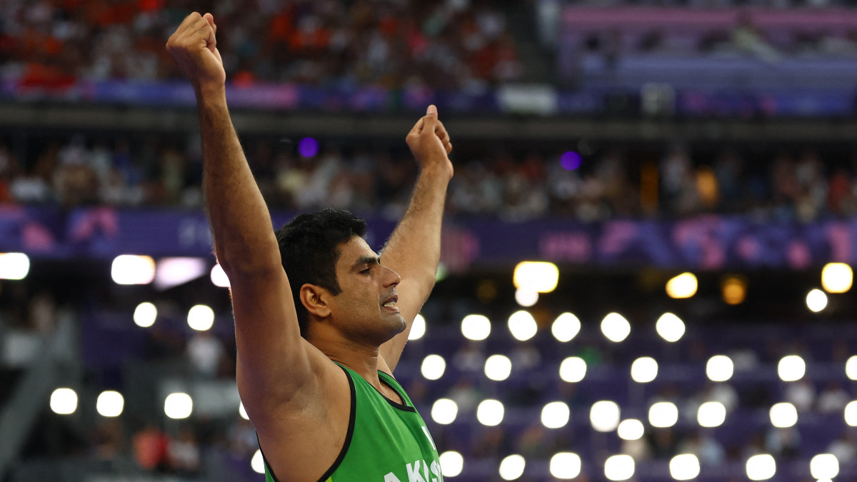 Pakistan's Arshad Nadeem raises his arms in celebration after smashing the Olympic record during the men's javelin final in the Paris Olympics. Reuters Pakistan's Arshad Nadeem raises his arms in celebration after smashing the Olympic record during the men's javelin final in the Paris Olympics. Reuters
