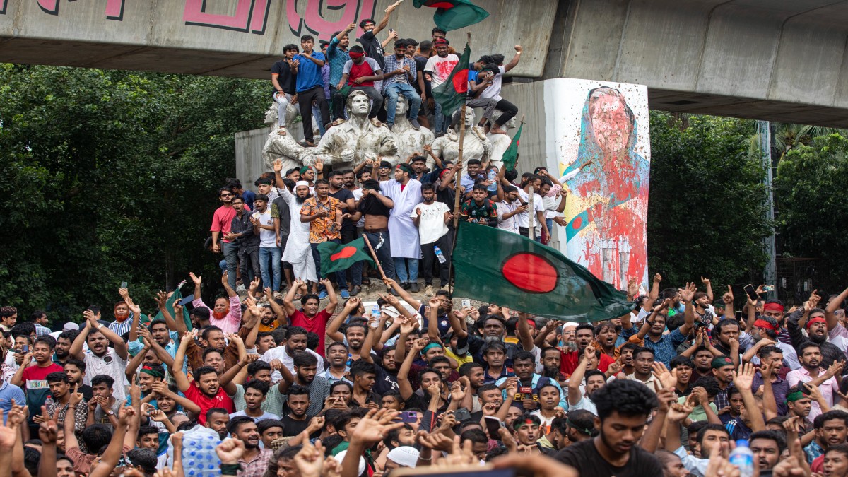 Protesters climb a public monument as they celebrate the news of Prime Minister Sheikh Hasina's resignation, in Dhaka, Bangladesh. AP Protesters climb a public monument as they celebrate the news of Prime Minister Sheikh Hasina's resignation, in Dhaka, Bangladesh. AP