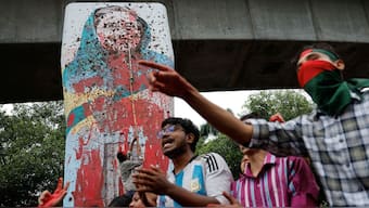 Protesters shout slogans as they vandalise a mural of then Bangladeshi Prime Minister Sheikh Hasina with paint and mud, demanding her resignation at Teacher Student Centre (TSC) area of University of Dhaka in Dhaka, Bangladesh, August 3, 2024. File Image/Reuters