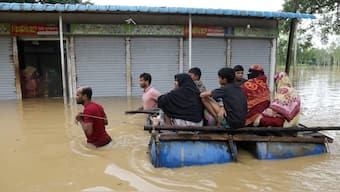 Flood-affected people move to a safe place after several districts flooded, at Chhagalnaiya in Feni, Bangladesh, August 23, 2024. Reuters