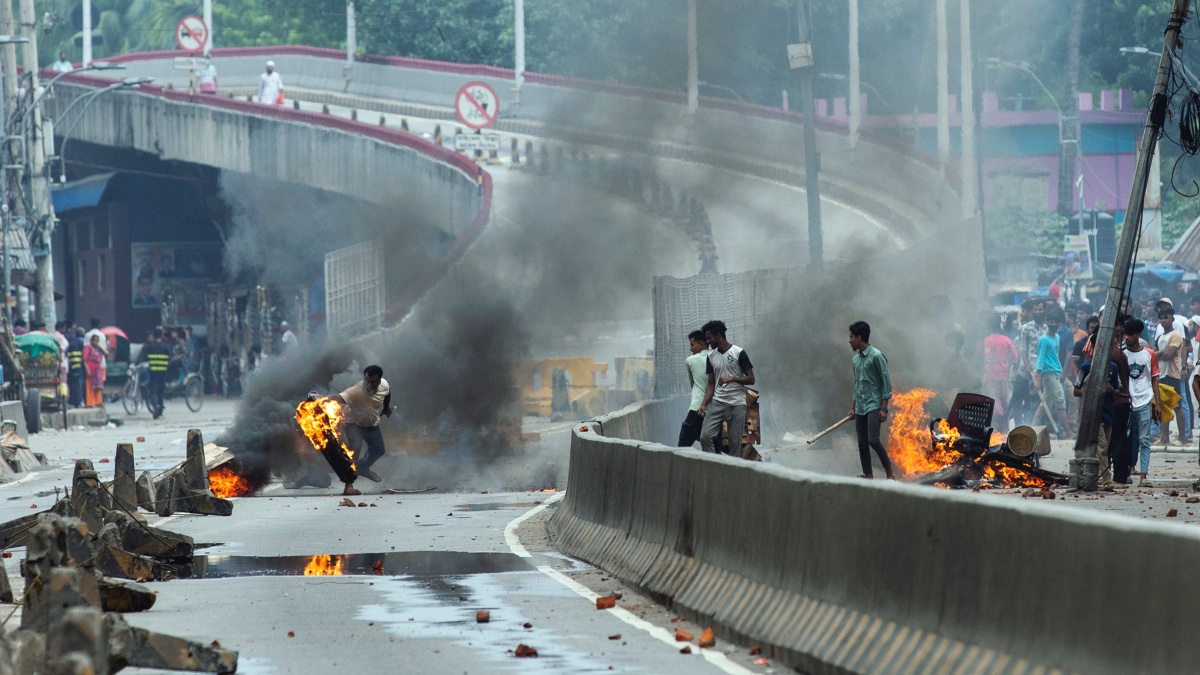 A protester throws a rubber tire on fire during a protest against Prime Minister Sheikh Hasina and her government in Dhaka. AP A protester throws a rubber tire on fire during a protest against Prime Minister Sheikh Hasina and her government in Dhaka. AP