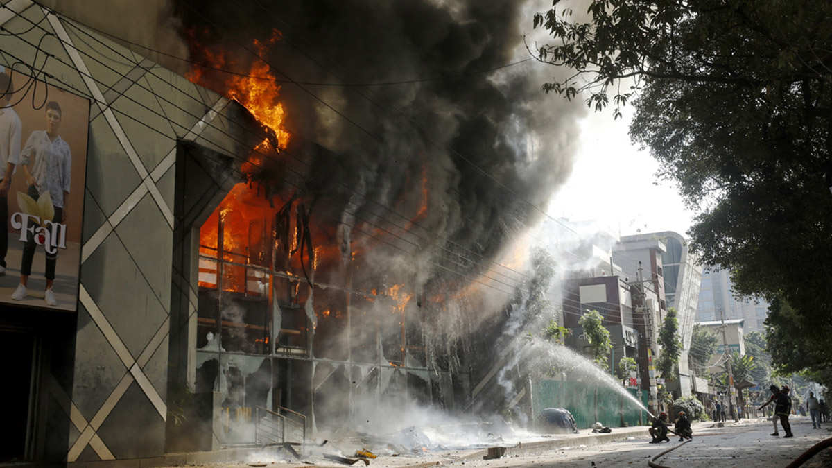 Firefighters douse a fire engulfing a shopping center which was set on fire by protesters during a rally against Sheikh Hasina and her government, Dhaka, Bangladesh, August 4, 2024. File Photo- AP Firefighters douse a fire engulfing a shopping center which was set on fire by protesters during a rally against Sheikh Hasina and her government, Dhaka, Bangladesh, August 4, 2024. File Photo- AP