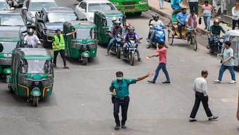 A police officer regulates a busy traffic intersection in Dhaka, Bangladesh. PTI