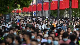 People walk along a pedestrian street during a Labor Day holiday in Shanghai on May 1. AFP