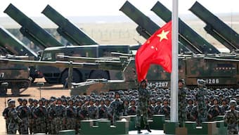 (File) Chinese People's Liberation Army (PLA) troops perform a flag raising ceremony. AP