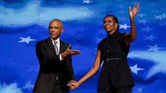 Former US first lady Michelle Obama greets her husband, former US President Barack Obama, on stage during Day 2 of the Democratic National Convention (DNC) in Chicago, Illinois, US, August 20, 2024. Reuters