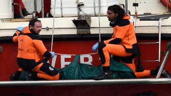 Italian firefighter scuba divers bring ashore, in the green bag, the body of one of the victims from the British-flagged vessel Bayesian, on Wednesday. AP