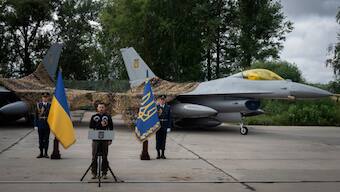 Ukraine's President Volodymyr Zelenskyy talks on the occasion of the Air Forces Day standing against the background of Ukraine's Air Force's F-16 fighter jets in an undisclosed location in Ukraine. AP