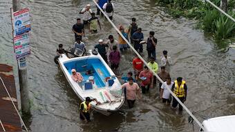 People bring a speed boat to rescue stranded residents in a flooded area of Feni, a coastal district in southeast Bangladesh, Friday, Aug. 23, 2024. Reuters