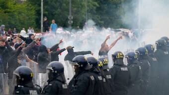 Police officers face protesters during an anti-immigration demonstration outside the Holiday Inn Express in Rotherham, England, Sunday Aug. 4, 2024.- Image- AP