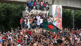 Protesters climb a public monument as they celebrate after getting the news of Prime Minister Sheikh Hasina's resignation, in Dhaka, Bangladesh, Monday, Aug. 5, 2024. File Image: AP