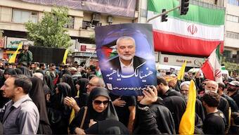 Iranians hold up a portrait of Ismail Haniyeh at his funeral, Tehran, August 1, 2024. Image: AFP