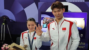 Huang Yaqiong (left) displays the diamond ring that fellow Chinese shuttler Liu Yuchen put on her finger after proposing marriage to her. Reuters