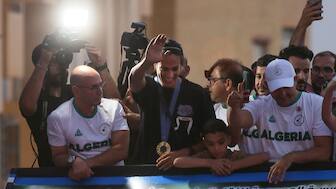 Paris Olympics gold medallist Imane Khelif waves to fans from the top of a double-decker bus in her hometown of Tiaret in Algeria. AP