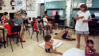 Israeli mothers and children spend the morning in a local bomb shelter after a barrage of Hezbollah-fired Katyusha rockets exploded in the area August 19, 1997. File Image/Reuters