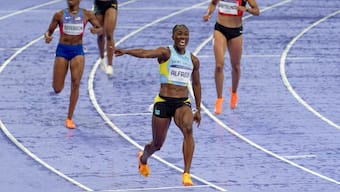 Saint Lucia's Julien Alfred celebrates after winning the women's 100-metre dash ahead of USA's Sha'Carri Richardson and Melissa Jefferson in the Paris Olympics. AP
