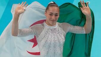 Kaylia draped the Algerian banner behind her after clinching her victory. AP 