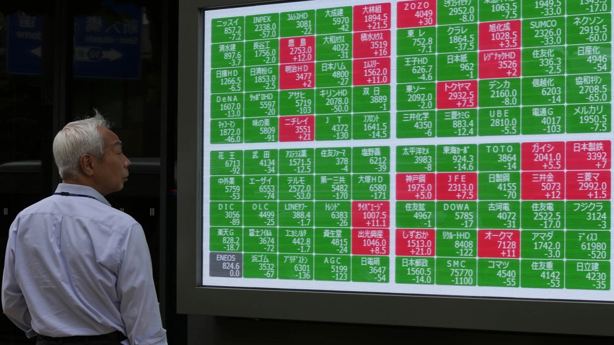 A passerby looks at a electronic stock board showing Japan's Nikkei 225 index at a securities firm in Tokyo. AP A passerby looks at a electronic stock board showing Japan's Nikkei 225 index at a securities firm in Tokyo. AP