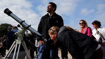 A woman uses a telescope to observe the planet Mercury transit in front of the sun outside Buenos Aires' planetarium, Argentina, May 9, 2016. File Image/Reuters
