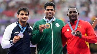 Neeraj Chopra (silver), Arshad Nadeem (gold) and Anderson Peters (bronze) pose with their respective medals during the Paris Olympics men's javelin medal ceremony. AP