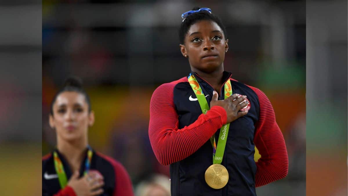 Simone Biles of the US tears up as she poses with her gold medal after winning the Women's Individual All-Around event in Artistic Gymnastics at the Rio Olympic Arena, Rio de Janeiro, Brazil, August 11, 2016. File Image/Reuters