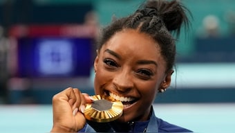 Simone Biles celebrates after winning gold at the women's artistic gymnastics all-around final at the Paris Olympics. AP  