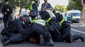 Police officers detain a demonstrator during a protest against illegal immigration outside of Downing Street in London, UK, July 31, 2024. Reuters