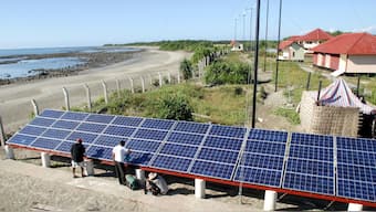 Bangladeshi experts fix a solar panel as part of efforts to maintain bio-diversity in the area and develop eco-tourism on Saint Martin Island, November 29, 2004. File Image/Reuters