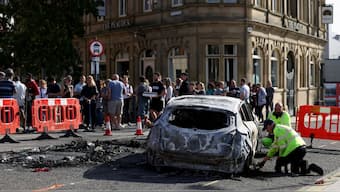 A burnt car is removed after a night of violent anti-immigrant demonstrations, in Sunderland, UK, August 3, 2024. Reuters