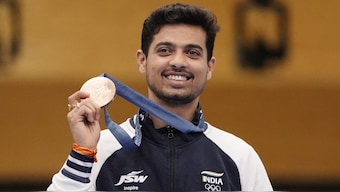 Swapnil Kusale with the bonze medal he won in 50m rifle 3 positions event at Paris Olympics 2024. Reuters
