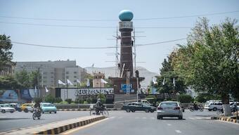 Taliban and municipal workers install banners at Ahmad Shah Massoud square on the eve of the third anniversary of Taliban takeover of Afghanistan, in Kabul. AFP