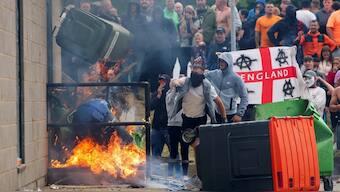 Rioters throw a garbage bin on fire outside a hotel in Rotherham, Britain, on August 4, 2024. Image: Hollie Adams/Reuters