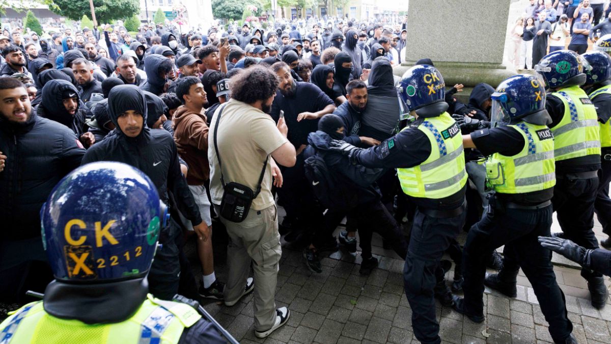 Police officers stand guard as counter-protesters push against the police cordon on the day of a protest against illegal immigration, in Bolton, UK, August 4, 2024. Reuters Police officers stand guard as counter-protesters push against the police cordon on the day of a protest against illegal immigration, in Bolton, UK, August 4, 2024. Reuters