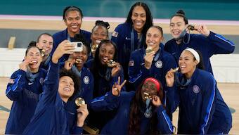 The US women's basketball team poses with their gold medals after defeating hosts France 67-66 to win gold. AP