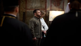 In this photo provided by the Ukrainian Presidential Press Office, Ukrainian President Volodymyr Zelenskyy and his wife Olena attend a service in Saint Sophia Cathedral during celebration of the Ukrainian Independence Day in Kyiv, Ukraine, on Saturday. AP