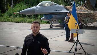 Ukraine's President Volodymyr Zelenskyy answers media questions standing against the background of Ukraine's Air Force's F-16 fighter jets in an undisclosed location in Ukraine, on August. 4, 2024. AP