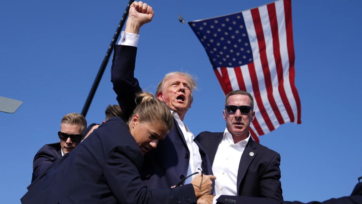 Secret Service agents whisk away Donald Trump, who raises his fist in the air after being shot in a foiled assassination bid. AP File Secret Service agents whisk away Donald Trump, who raises his fist in the air after being shot in a foiled assassination bid. AP File