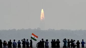 People watch as a rocket takes off at Sriharikota, Andhra Pradesh (Photo: AFP)