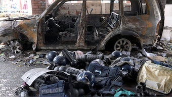 Damaged riot gear of security forces is seen next to a burnt vehicle outside a police station, days after the resignation of former Bangladeshi Prime Minister Sheikh Hasina, in Dhaka, Bangladesh, August 8, 2024. Reuters