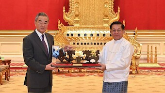 This photograph taken and released on August 14, 2024 by the Myanmar Military Information Team shows Myanmar's military chief Min Aung Hlaing (R) meeting with China's Foreign Minister Wang Yi in Naypyidaw. File image/AFP