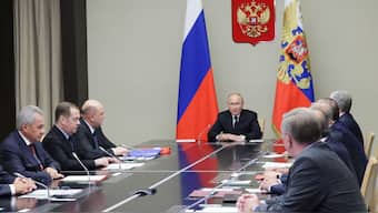 Russian president Vladimir Putin with others. August 16, 2024. Sputnik/Reuters