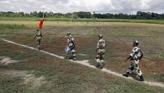 Indian Border Security Force (BSF) soldiers walk across the open border with Bangladesh to attend a flag meeting in West Bengal, India, June 20, 2015. REUTERS