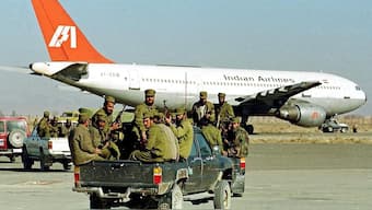 Taliban Islamic militia commandos head towards the hijacked Indian Airlines plane at Kandahar airport in Afghanistan, December 30, 1999.  File Photo/AFP